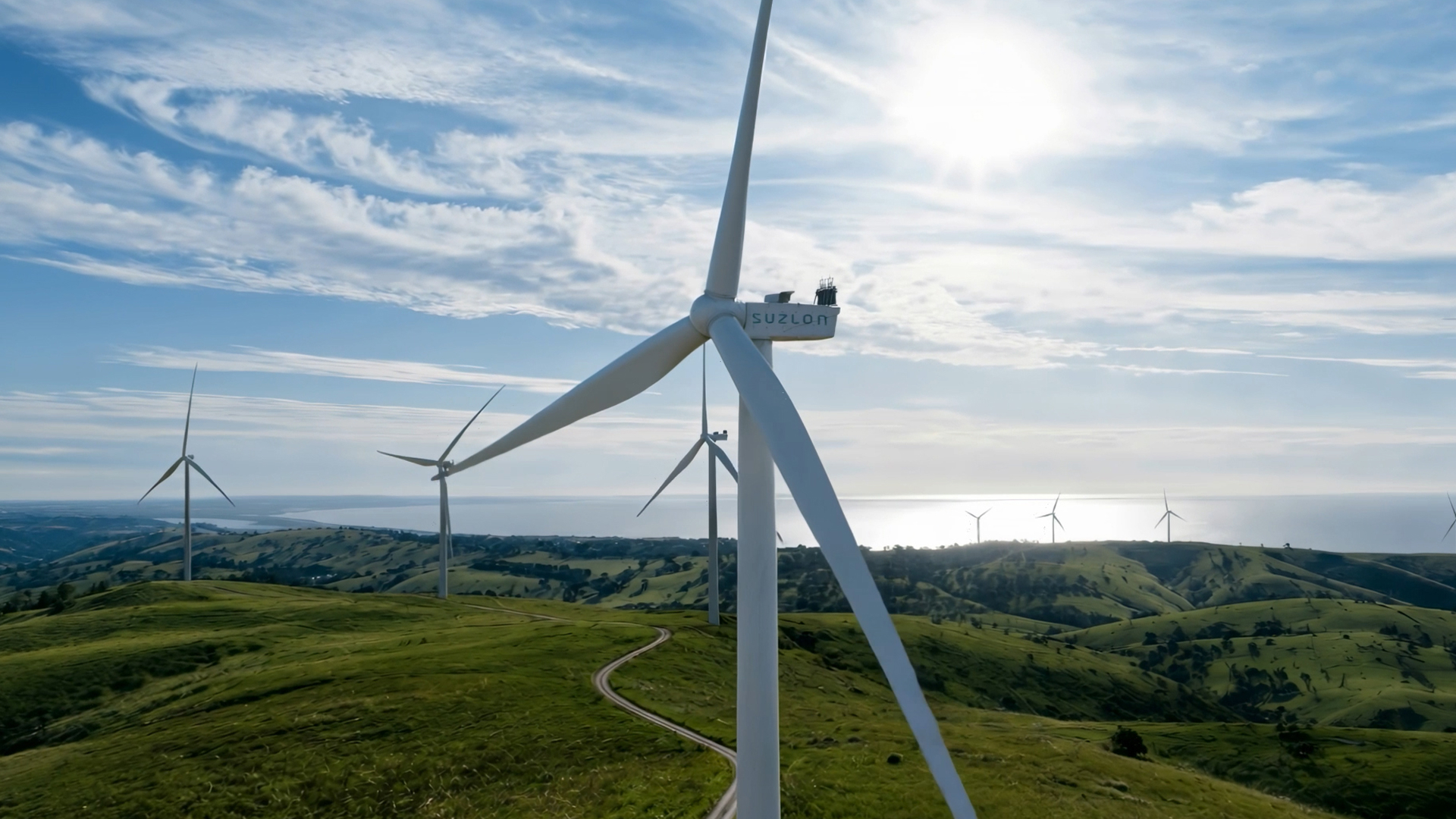 Suzlon wind turbine nacelle aerial view over green fields
