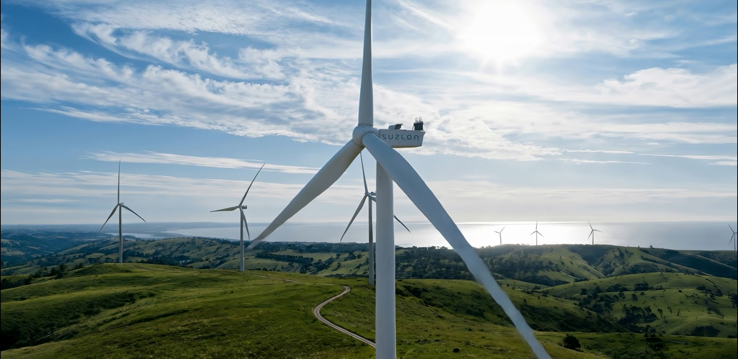 S144 wind turbine tower and blades against blue sky