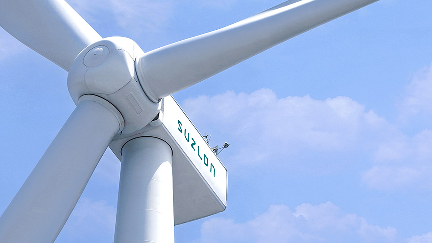 S144 wind turbine tower and blades against blue sky